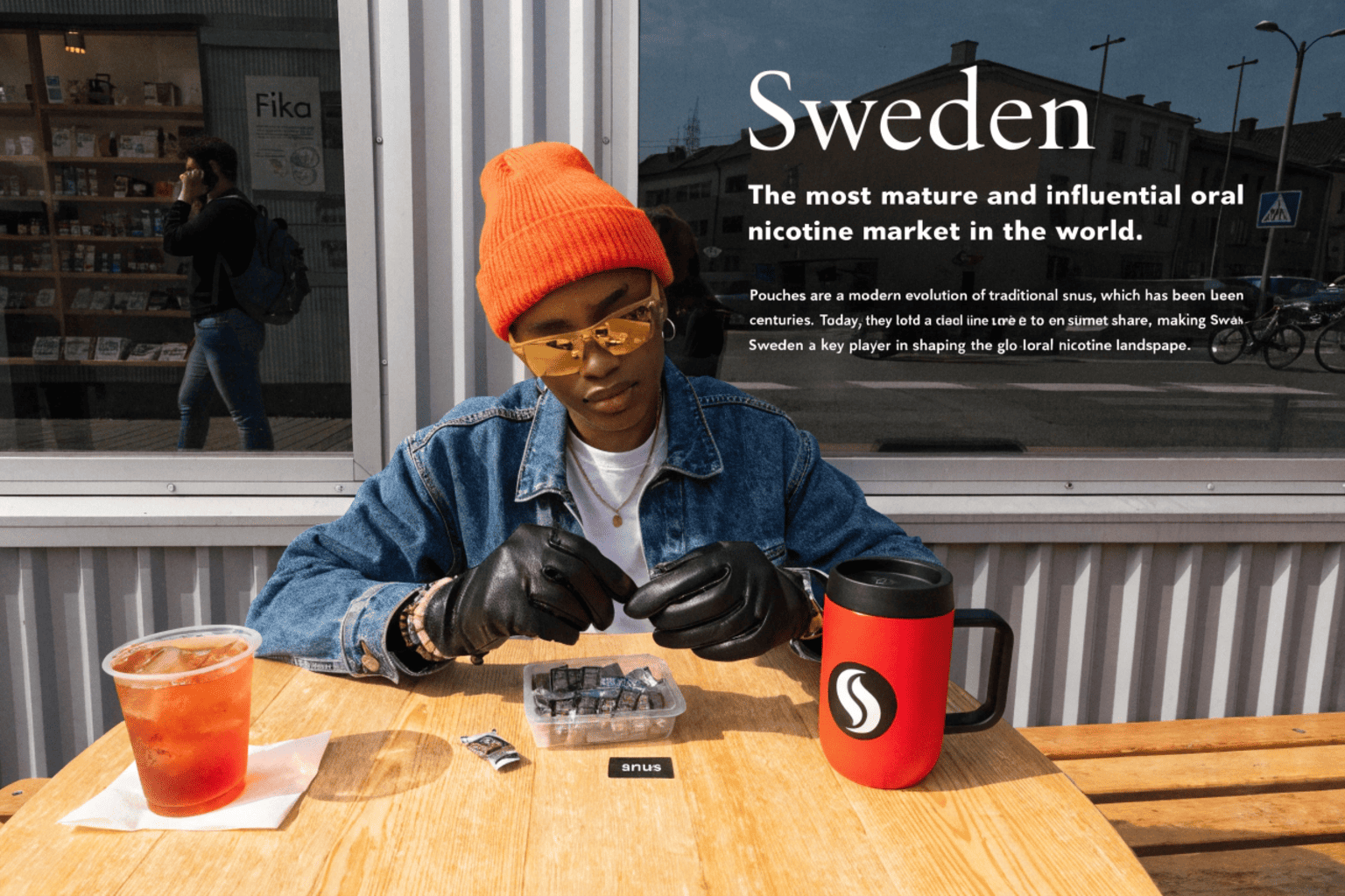 A candid shot of a group of friends in Stockholm enjoying coffee, with some using nicotine pouches.