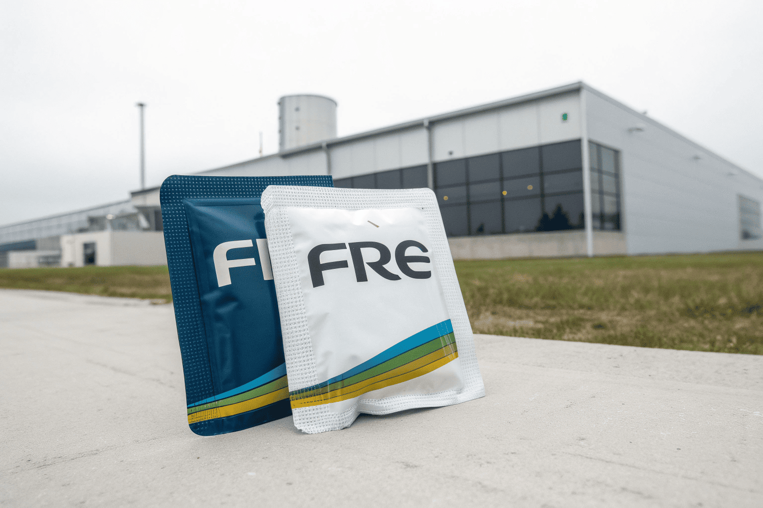 Where FRE Nicotine Pouches Are Made A can of FRE pouches in front of a factory setting with a question mark.