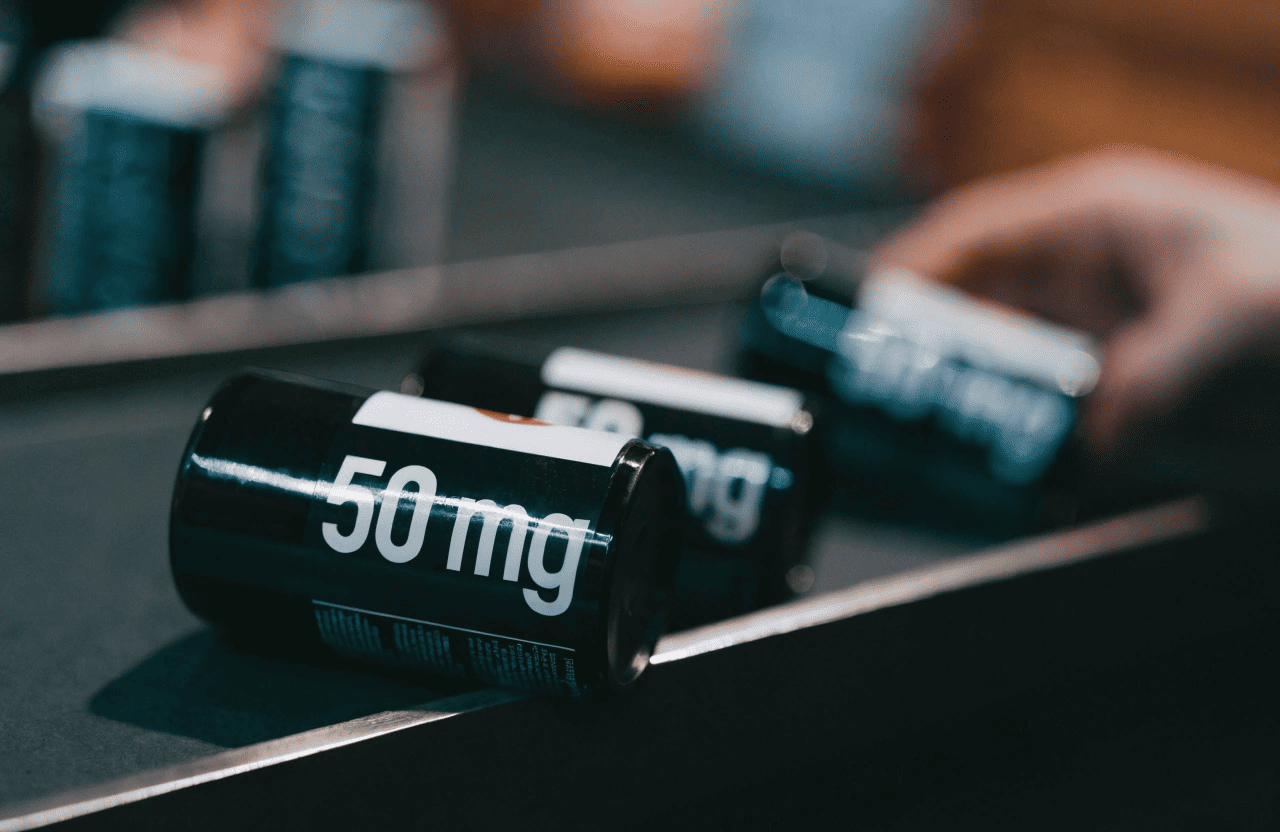 A graphic showing the math: '50 mg/g' pointing to a pile of filler, then an arrow to a pouch labeled '0.8g' with '40mg' below it.